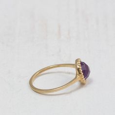 Purple Amethyst ring A dainty gold ring set at its center with a natural Amethyst gemstone. The stone is milgrain set with much attention to detail giving it an antiquated look. Handmade to perfection to bring out the purple beauty and clarity of this amethyst gemstone. Perfect for stacking with chevron rings. -Made to Order, perfectly finished, Fast shipping fully insured and trackable online. -Gemstone info: 7 mm Amethyst, Cabochon cut. -Ring width: 1.4 mm -Arrives gift ready with a certificat Purple 14k Gold Fine Jewelry Rings, Purple Amethyst Ring In 14k Gold, 14k Gold Purple Amethyst Ring, 14k Gold Amethyst Ring With Purple Gemstone, Fine Jewelry Amethyst Gold Ring, Amethyst Yellow Gold Rings Fine Jewelry, Fine Jewelry Amethyst Ring In Yellow Gold, Fine Jewelry Gold Amethyst Ring, Fine Jewelry Gold Ring With Amethyst