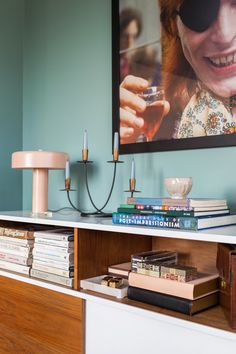 a book shelf with books and glasses on it