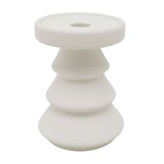 a white ceramic candle holder on a white background with the top turned to look like a cone