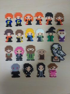 an assortment of pixelated characters are displayed on a white surface in front of a wall