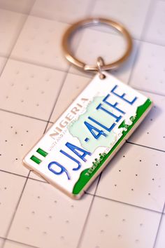 a metal keychain with the name atlanta on it sitting on a tile floor