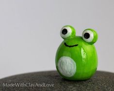 a close up of a green toy with eyes