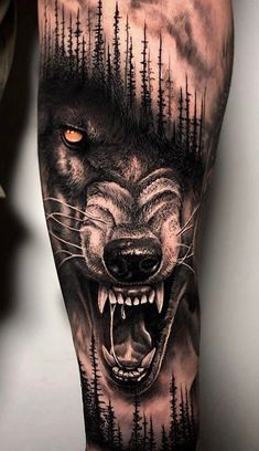 a man's arm with a wolf tattoo on it and trees in the background