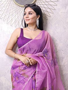 Providing a fantasy of heaviness but super convenient to carry and flaunt, this elegant lavender color saree is made with organza material accomplished with floral and foil printing work. This beautiful lavender saree comes with a purple color blouse made with heavy banglory material. This attractive lavender saree is 5.50 meters long and comes with unstitched 1.00-meter blouse material. This attractive lavender floral print saree with a purple blouse looks rich and gorgeous for a party or any o Purple Tissue Silk Pre-draped Saree With Sheer Dupatta, Purple Organza Pre-draped Saree For Diwali, Purple Georgette Pre-draped Saree For Festivals, Purple Organza Pre-draped Saree With Dupatta, Festive Sheer Organza Saree, Purple Blouse Piece With Sheer Dupatta, Festive Sheer Saree, Traditional Sheer Saree For Festive Occasions, Traditional Sheer Organza Saree