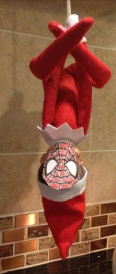 a spiderman stuffed animal hanging from the ceiling