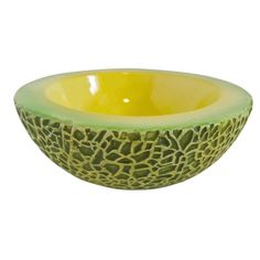 a green and yellow bowl sitting on top of a white table