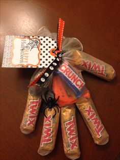 halloween candy wrapped in cellophane and tied up on a table with a tag