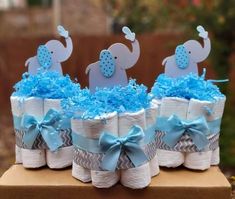 three diaper cakes with elephants on them