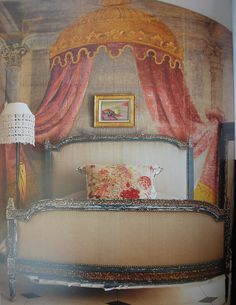 an image of a bed with red drapes on the headboard and foot board