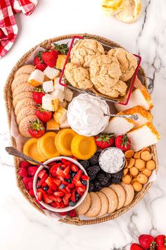 a basket filled with lots of different types of food on top of a white table