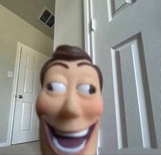 the face of a cartoon character is shown in front of an open door