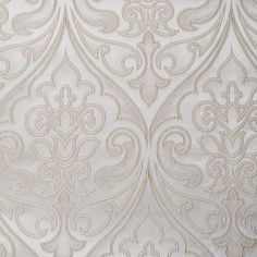 an upholstered white fabric with intricate designs