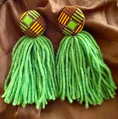 Green Kente Fabric Button Tassel Earrings, lightweight earrings, soft yarn, African Fabric, stainless steel post. Approx. 5inches Diy Yarn Earrings, Yarn Earrings, Raffia Earrings, Kente Fabric, Rainbow Ombre, African Earrings, Fabric Earrings, Yarn Diy, Steel Post