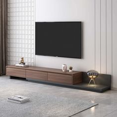 a flat screen tv sitting on top of a wooden entertainment center