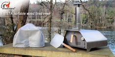 an outdoor wood fired oven sitting next to a lake