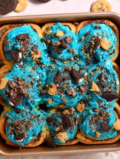 a cookie doughnut with blue frosting and chocolate chips on top in a baking pan