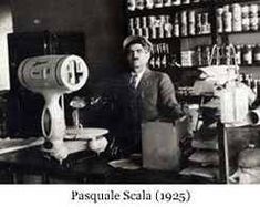 an old black and white photo of a man in a barbershop with a hair dryer