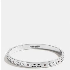 a white bang bracelet with diamonds on the side and an inscription that reads, i love you