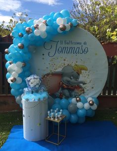 an elephant balloon arch with blue and white balloons for a baby's first birthday