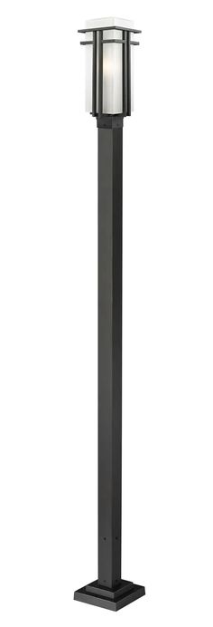 an outdoor post light that is on top of a black metal pole with a white glass shade