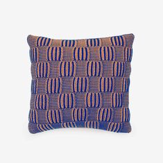 a blue and orange pillow with circles on it, against a white background the pillow is made out of woven fabric