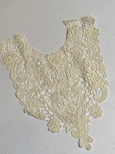 This is a wonderful ecru color heavy lace modesty insert. the size is approximately 11.5x13. Fitted White Crochet Lace Top, White Fitted Crochet Lace Top, Fitted Cream Lace Top With Lace Patchwork, Fitted Cream Lace Top With Patchwork, Spring Cream Lace With Patchwork, Fitted Cream Lace With Lace Patchwork, Fitted Cream Lace With Patchwork Detail, White Scalloped Lace Top, Fitted Off White Lace Top