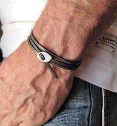 "Mens Grey flat leather cuff, leather wrap bracelet, silver adjustable glasp bracelet, for him, mens , urban wrap cuff, mens bracelets Welcome to my shop! ✈️ DHL EXPRESS SHIPPING AVAILABLE, 1-3 BUSINESS DAYS DELIVERY! ✔️ PLEASE MAKE SURE TO SELECT IT, RIGHT BEFORE YOUR PURCHASE! ❗️ ❗️ DON'T FORGET TO ADD YOUR CELL # AT THE \"NOTE TO SELLER\" SECTION IF YOU CHOOSE DHL! BY FILLING YOUR CELL NUMBER YOU EARN THE BENEFIT TO CHOOSE BETWEEN 6 DIFFERENT DELIVERY OPTIONS! INSTRUCTIONS WILL BE SENT TO YOU Minimalist Silver Adjustable Leather Bracelet, Modern Adjustable Leather Bracelet With Waxed Finish, Modern Adjustable Bracelet With Waxed Finish, Minimalist Leather Bracelet With Adjustable Stainless Steel Clasp, Modern Adjustable Silver Wrap Bracelet, Masculine Leather Bracelet For Everyday, Modern Silver Wrap Bracelet For Everyday, Men’s Leather Bracelet, Masculine Silver Leather Bracelet