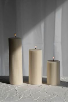 Indulge in the understated elegance of the Ribbed Pillar Candle Set - a Perfect Blend of Style and Serenity. This exquisite set features three ribbed pillar candles crafted to infuse your space with a warm and inviting ambiance, reminiscent of the tranquil Mediterranean atmosphere. Each pillar candle in the set is meticulously handcrafted, showcasing a ribbed texture that adds a touch of sophistication and visual appeal. The timeless design effortlessly complements any decor style, from modern t Pillar Candle Wedding, Wedding Candle Gift, Candle Minimalist, Gift Candle, Candle Craft, White Mark, Pillar Candle, Candle Set, Candle Gift