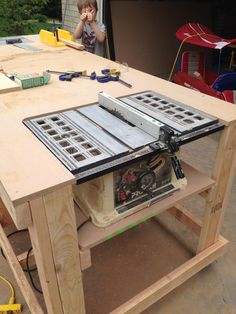 a table that has some tools on top of it with a woman in the background