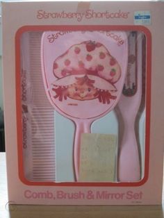 a pink baby brush and mirror set in a box