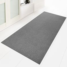 a black and white bathroom rug on the floor