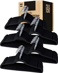 six pairs of black shoe clips in front of a box