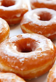 there are many glazed donuts with icing on them