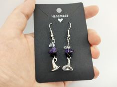 A pair of witch hat earrings, with three crystal chips above: black obsidian, purple amethyst, and clear quartz. This would be an ideal gift for a Pagan, Wicca, Druid, or other witchy person. The ear wires are silver plated, and the jewellery comes displayed on a black card as shown in the pictures. You can choose to have this presented in a pretty paper bag or a black velvet gift pouch. --- *Handmade in England* by an English druid with Scottish and Irish roots. Please note, your order will not Witch Hat Earrings, Pouch Handmade, Irish Roots, Crystal Chips, Black Card, Black Obsidian, Gift Pouch, Witch Hat, Purple Amethyst