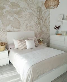 a bedroom with a bed, nightstands and wallpaper