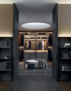 a walk in closet with shelves and clothes on the walls, along with a footstool