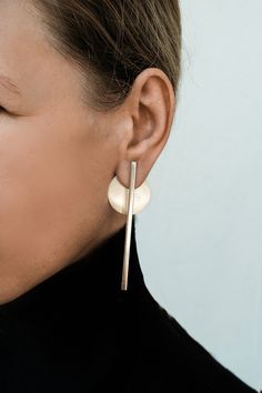 "Long Sterling silver ear jacket gold line earrings, Front back earring jacket, Modern statement earrings, Double earrings, Bar ear jacket Earrings are available in brass and silver, or both (brass bars + silver circles). For brass go to: https://www.etsy.com/uk/shop/MoonkidJewelry?ref=seller-platform-mcnav&section_id=25817872 These modular earrings with sterling silver posts and backs are polished to give them a soft matte texture. Each earring consists of 2 parts that can be detached from each Modern Silver Ear Climbers, Line Earrings, Extra Long Earrings, Gold Ear Jacket, Jacket Earrings, Double Earrings, Double Sided Earrings, Large Statement Earrings, Earrings Double