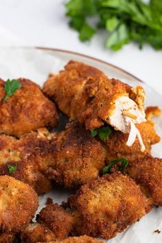 some fried food on a plate with parsley