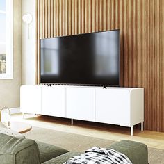 a flat screen tv sitting on top of a white entertainment center