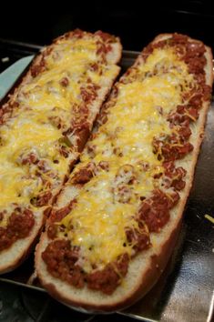 two long slices of bread covered in cheese and chili