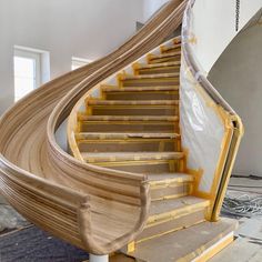 a staircase being constructed with wood and plastic covering the treads on each handrail