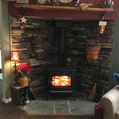 a living room filled with furniture and a fire place in the middle of the room