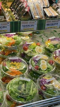 salads in plastic containers on display at a grocery store