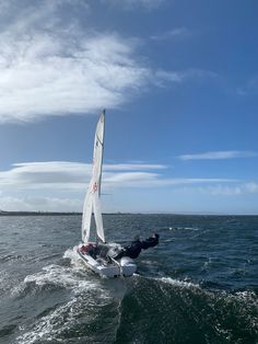 a person on a sailboat in the water