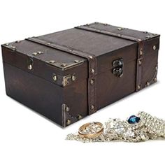 an old trunk and some jewelry on a white background