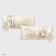 three pillows with mickey mouse designs on them and tags attached to the pillowcases