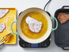 two pans filled with food sitting on top of a stove next to each other