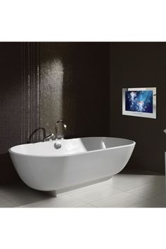 a white bath tub sitting on top of a tiled floor