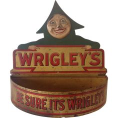 an old fashioned wrigley's sign with a creepy face on the front