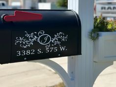 a black mailbox with a red arrow on the front and white lettering that says, 532 s 527 w